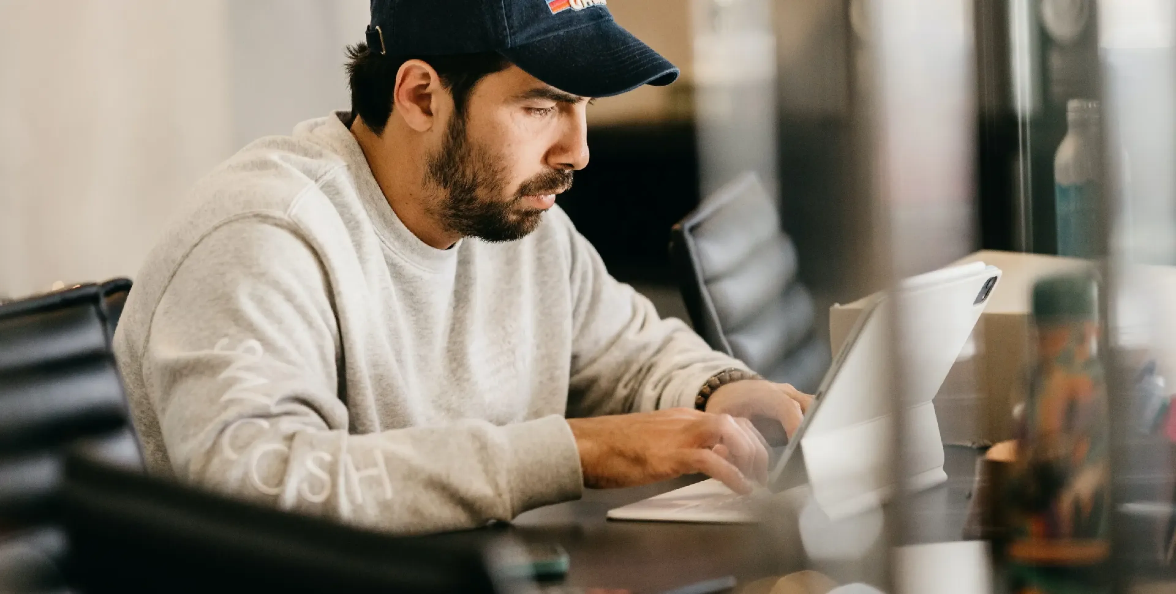 Designer working on a tablet keyboard at a modern studio desk