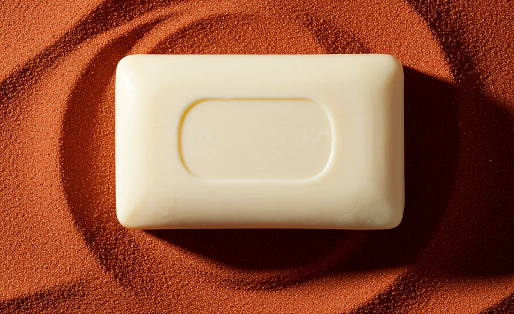 Monochrome figure against an orange backdrop