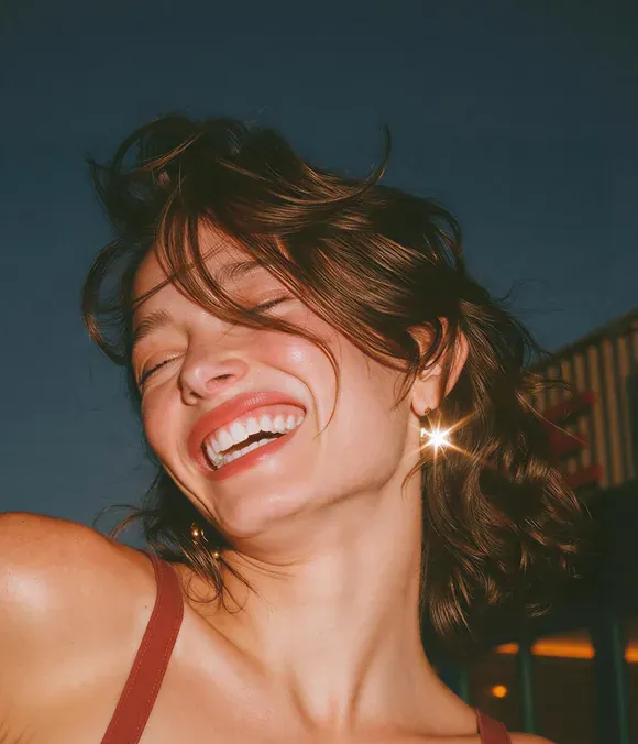 Portrait of a smiling woman in warm studio light